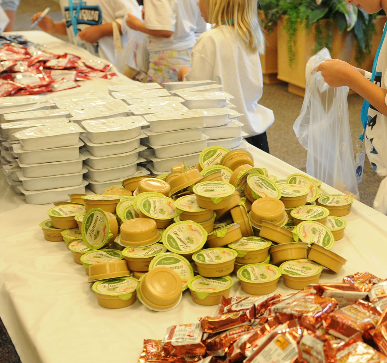 A volunteer packs food for The Food Group
