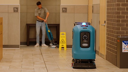 X4 ROVR Autonomous Floor Scrubber and staff member with i-mop Lite cleaning a retail facility