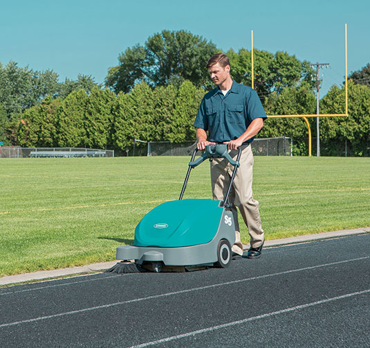 S5 Walk-Behind Sweeper Cleaning Outdoors at a School