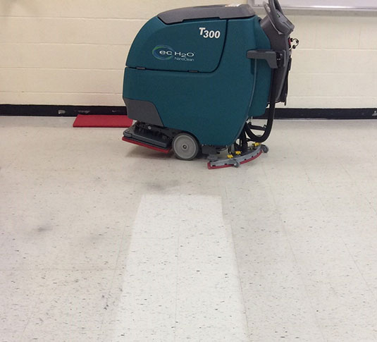 Floor finish removed using an orbital floor scrubber