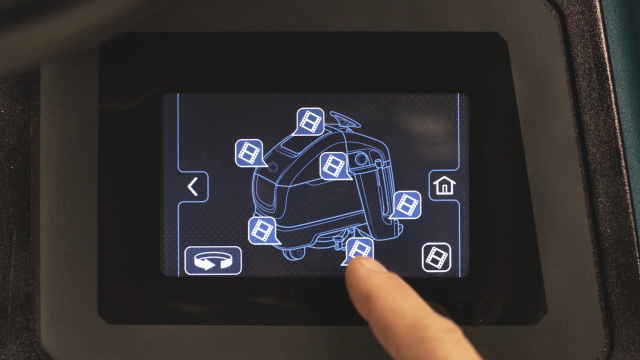 An employee chooses a training topic from an on demand library on a control panel.