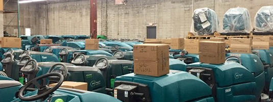 A warehouse filled with used floor scrubber Recon machines ready for sale