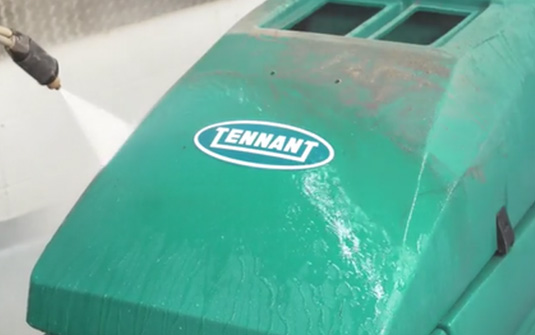Reconditioned Tennant floor scrubber being washed.