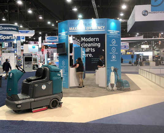 ISSA 2019 Tennant Tradeshow Booth with T7 AMR, iMop and floor scrubber displayed