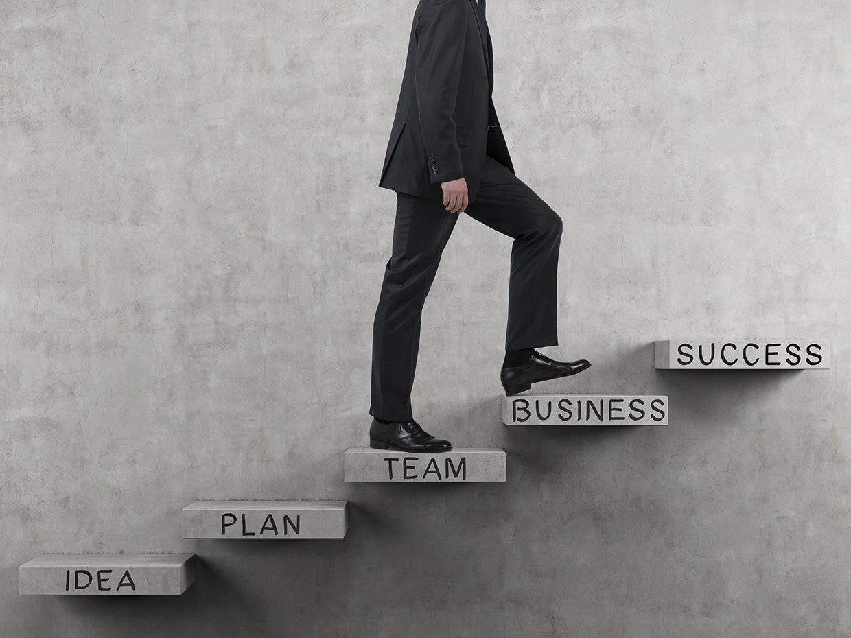 Business Person Walking Up Success Steps