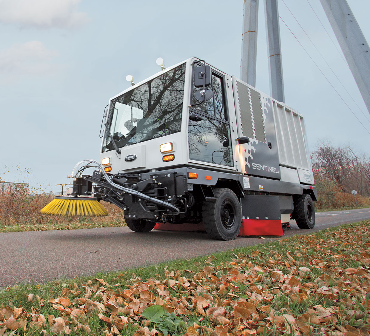 Sentinel Rider sweeper cleaning outdoors in autumn