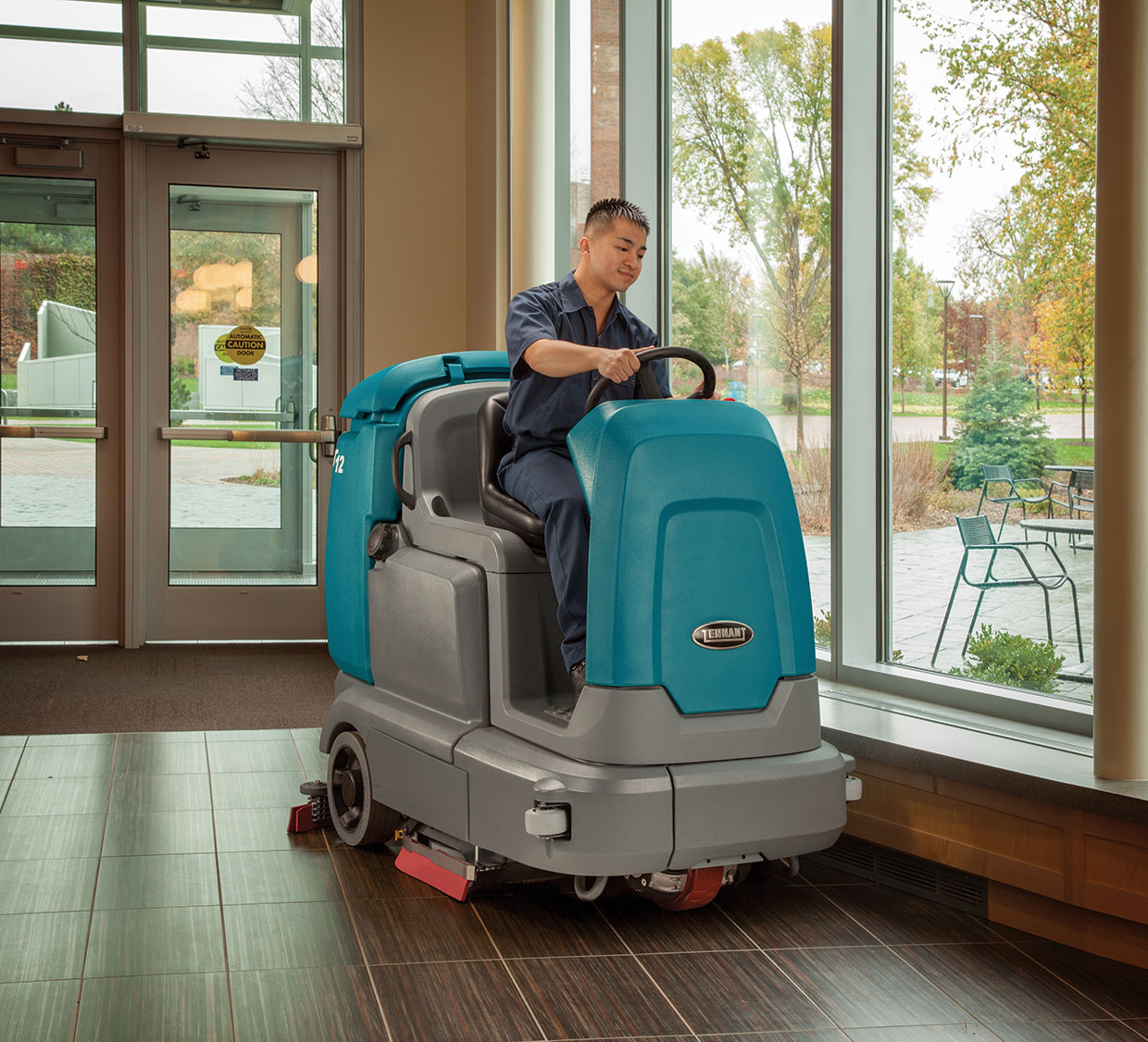 A T12 scrubber cleans a building lobby