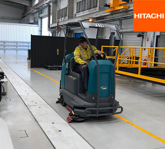 Tennant T12 Ride-On Scrubber cleaning a manufacturing facility