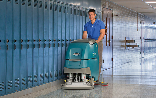 janitor cleaning school hallways during the summer