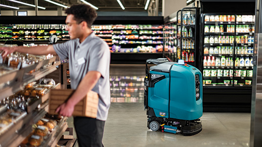 X4 ROVR Autonomous Floor Scrubber cleaning in a grocery store