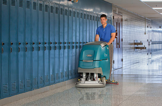 T500 walk-behind scrubber cleaning school by lockers