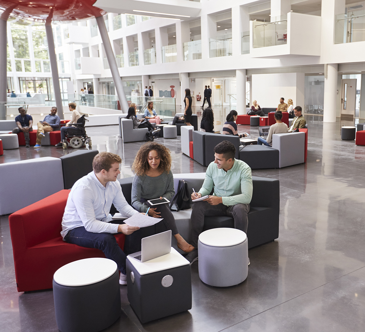 Students sitting in university atrium