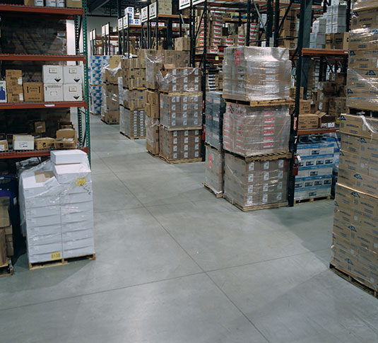 A warehouse aisle. Keeping aisles clean and free of clutter contributes to efficient warehouse operations.