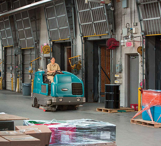 T20 Rider Floor Scrubber Cleaning a Logistics Facility