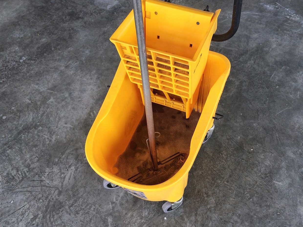 Traditional mop and bucket with dirty water