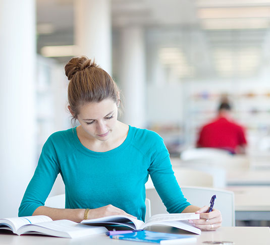 A student studies in a library. Cleaning in quiet areas can pose extra challenges.