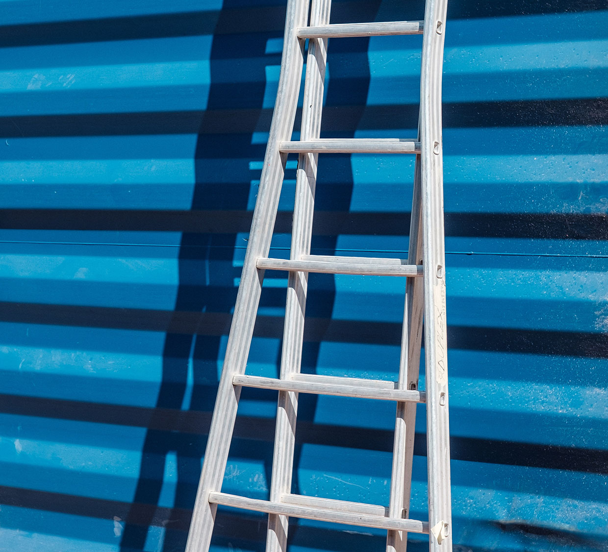 Ladder against blue wall