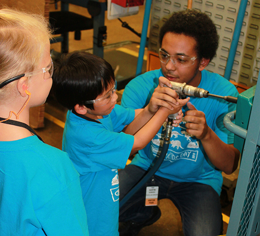 Child helping weld at Tennant Kids Day